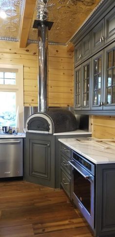 a stove top oven sitting inside of a kitchen