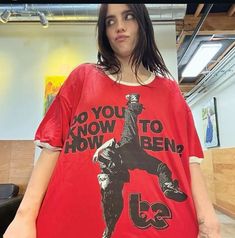 a woman wearing a red t - shirt that says do you know to snowboard?