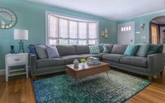 a living room with blue walls and wooden floors