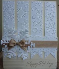 a white card with brown ribbon and bow on it's side, decorated with snowflakes