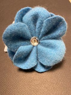 "Handmade, one of a kind, pin/brooch. I hand felt wool sweaters to create my own felted wool.  This pin design is a flower bud with button center. color is blue muted turquoise. It measures approximately 4\" across. Pin back, flower, and button mount are all stitched through the felt wool. Great piece for a sweater, hat, scarf, or jacket. Thank you for looking.  From my smoke free home." Recycled Sweaters Upcycling Felted Wool, Felt Flower Pins Brooches, Unique Handmade Flower Brooch, Fabric Flower Brooch Inspire Uplift ⭐, Recycled Wool Sweater, Blue Flower-shaped Jewelry Brooch, Felt Ornaments Patterns, Fiber Art Jewelry, Scrap Fabric Crafts