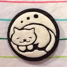 a white and black cookie with a cat on it