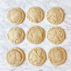 twelve cookies are arranged on a marble surface