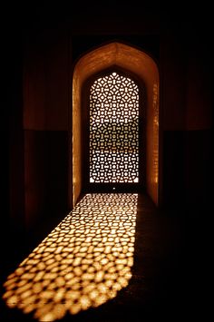 shadows cast on the wall and floor in an archway