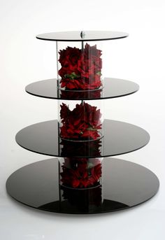 three tiered glass display with red roses in the center and bottom shelf on each side