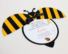 a bee themed birthday party with black and yellow stripes on it's head, sitting on top of a white table