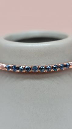 Handcrafted in a unique cut design, the Tina Diamond Bangle emanates maximum shine all around the band, with colored diamonds to add character to the piece. Available in blue or green diamonds. Dimensions: 17 cm (approx. 6.69 in) Materials used (pictured): 14K solid rose gold, 9.1 g10 x rough blue / green diamonds ﻿Note﻿: Only the Green Diamonds / Rose Gold option is Ready to Ship. Other options can be ordered but standard delivery times apply. Fine Jewelry Blue Diamond Cut Bracelets, Fine Jewelry Blue Diamond Cut Bracelet, Fine Blue Diamond Cut Bracelet, Blue Fine Jewelry Bangle For Gifts, Blue Fine Jewelry Bracelet With Single Cut Diamonds, Gift Rose Gold Bangle With Single Cut Diamonds, Fine Jewelry Blue Round Bangle, Sapphire Bracelets With Diamond Accents For Anniversary, Anniversary Bracelets With Sapphire And Diamond Accents