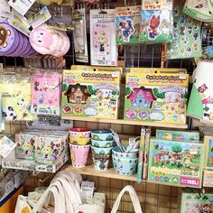 there are many bags and purses on the shelves in this store that is selling children's toys