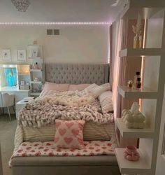 a bedroom with a large bed and lots of pillows