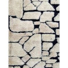 an area rug with black and white designs on it