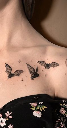 a woman's chest with bats and flowers on it