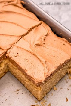 a cake with frosting sitting on top of a pan