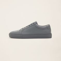 a picture of a grey leather sneaker