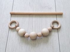 a wooden teethpick and some beads on the floor