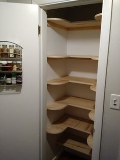 an empty pantry with shelves and spices