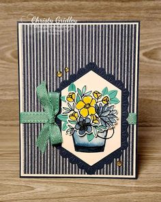 a close up of a greeting card with flowers on the front and blue stripes in the back