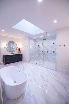 a large white bath tub sitting inside of a bathroom next to a walk in shower