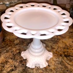 a white cake plate sitting on top of a counter