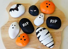 halloween rocks are decorated with black and white pumpkins, ghost faces, and the words rip on them