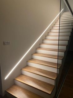 a set of white stairs with wooden treads