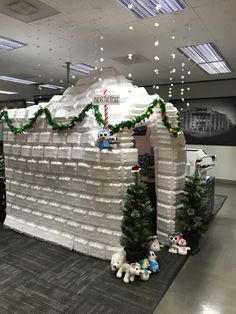 an office decorated for the holidays with fake snow and christmas garlands on it's roof