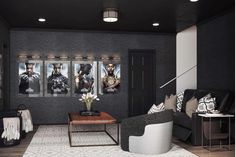 a living room filled with black furniture and pictures on the wall above it's doors