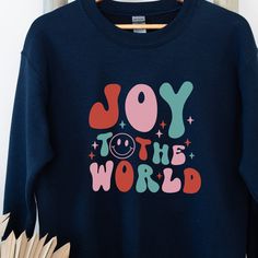 Joy to the world! Enjoy the Christmas season with this retro style holiday crewneck. Ideal for the holiday season, a unisex heavy blend crewneck sweatshirt is pure comfort. These garments are made from polyester and cotton. This combination helps designs come out looking fresh and beautiful. The collar is ribbed knit, so it retains its shape even after washing. There are no itchy side seams on these sweaters.  .: 50% cotton, 50% polyester .: Medium-heavy fabric (8.0 oz/yd² (271.25 g/m .: Loose f Holiday Crewneck, Winter Designs, 70s Shirts, Christmas Retro, Retro Sweater, Christmas Tshirt, Winter Shirts, Winter Design, Holiday Shirt