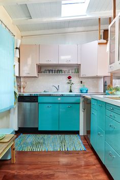 a kitchen with blue cabinets and wooden floors is pictured in this image from the inside