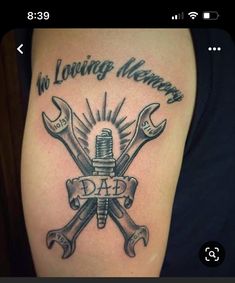 a tattoo with wrenches and the words in loving memory, dad on it's arm