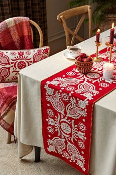 a red and white table cloth on a dining room table