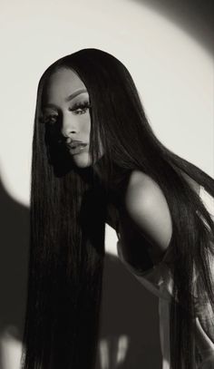 a black and white photo of a woman with long hair