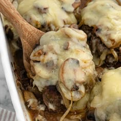 a casserole dish with mushrooms and cheese on top, ready to be eaten