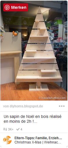 a wooden christmas tree sitting on top of a table