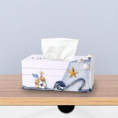 a tissue box sitting on top of a wooden table