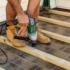 a man using a power drill on some steps