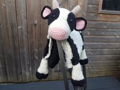 a stuffed cow sitting on top of a chair