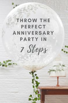 a clear balloon with the words throw the perfect anniversary party in 7 steps on it