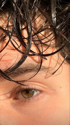 a close up of a person's head with lots of hair on top of it