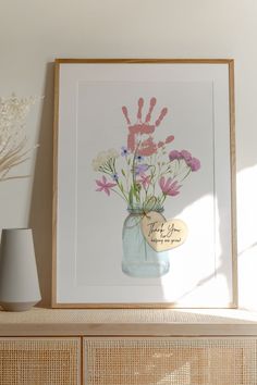 a vase filled with flowers sitting on top of a shelf