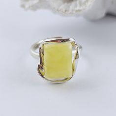 Natural Yellow Baltic Amber Ring, Yellow Amber Ring, Amber And Sterling Silver Ring, Baltic Amber Jewelry, Amber Gift For Her, Yellow Amber Amazing adjustable ring made of natural Baltic amber and sterling silver. Yellow Baltic Amber ring. Really stunning,  Baltic amber ring in a beautiful yellow color. This handmade ring is made of 100% natural, polished Baltic amber and sterling silver. Weight: 6.92 g Dimensions: approx. 1,6 x 1,3 x 0,9 cm / 0.62 x 0.51 x 0.35 inch Size: adjustable Sterling silver 925 It's a handmade product, each item is unique. Great as a gift. Each of our products is packed in a beautiful gift box. Baltic amber manufacturer and seller from Poland. Our jewelry, beads and other goods shop: https://www.etsy.com/shop/FineBalticJewelry Shipping time to your country: Europe Yellow Rectangular Ring As A Gift, Yellow Rectangular Ring For Gift, Yellow Rectangular Rings For Gift, Yellow Sterling Silver Open Ring, Untreated Amber Jewelry Gift, Unique Handmade Yellow Rings, Adjustable Sterling Silver Yellow Ring, Adjustable Yellow Sterling Silver Rings, Adjustable Yellow Rings Suitable For Gifts