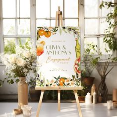 an easel with a sign and flowers on it