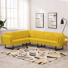 a yellow sectional sofa sitting on top of a rug