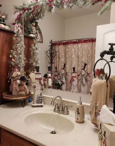 a bathroom sink with christmas decorations on the counter