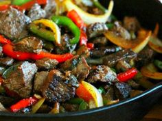 beef and peppers stir fry in a skillet