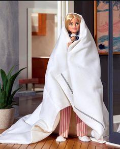 a barbie doll wrapped up in a blanket