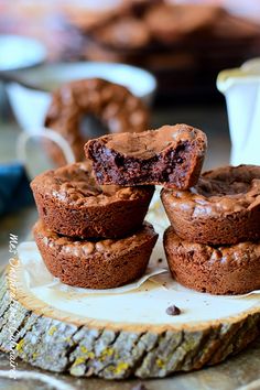 chocolate cupcakes stacked on top of each other with one cut in half to show the inside