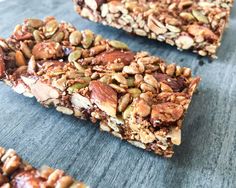 three granola bars with nuts and seeds on top