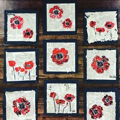 six red flowers are on white paper with black trim around the edges and in squares