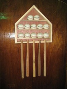 a wooden display case with baseballs and bats