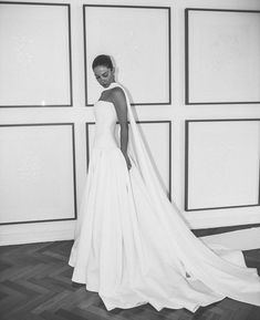 a black and white photo of a woman in a wedding dress